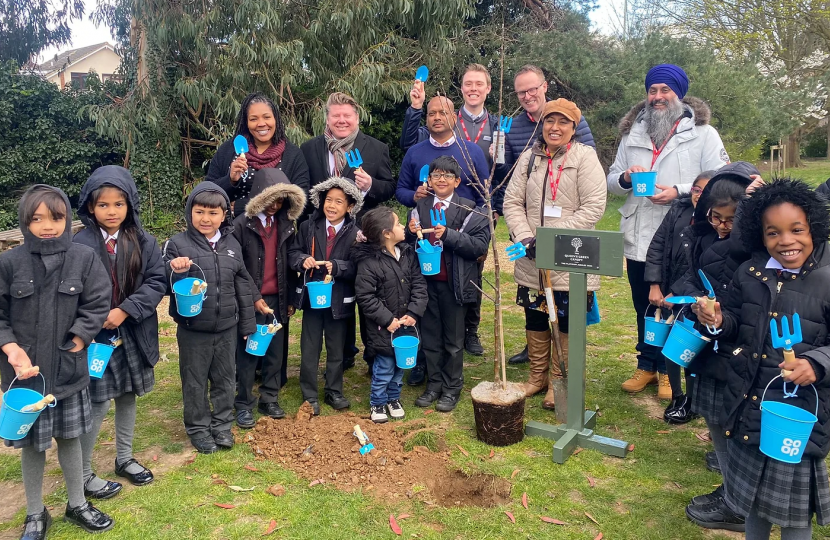 Dean Russell planting apple trees at Stanborough Primary School