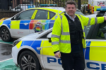 Dean Russell MP standing by police car at Watford Police Station