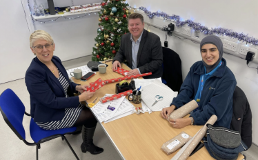 Dean Russell helps with Christmas wrapping